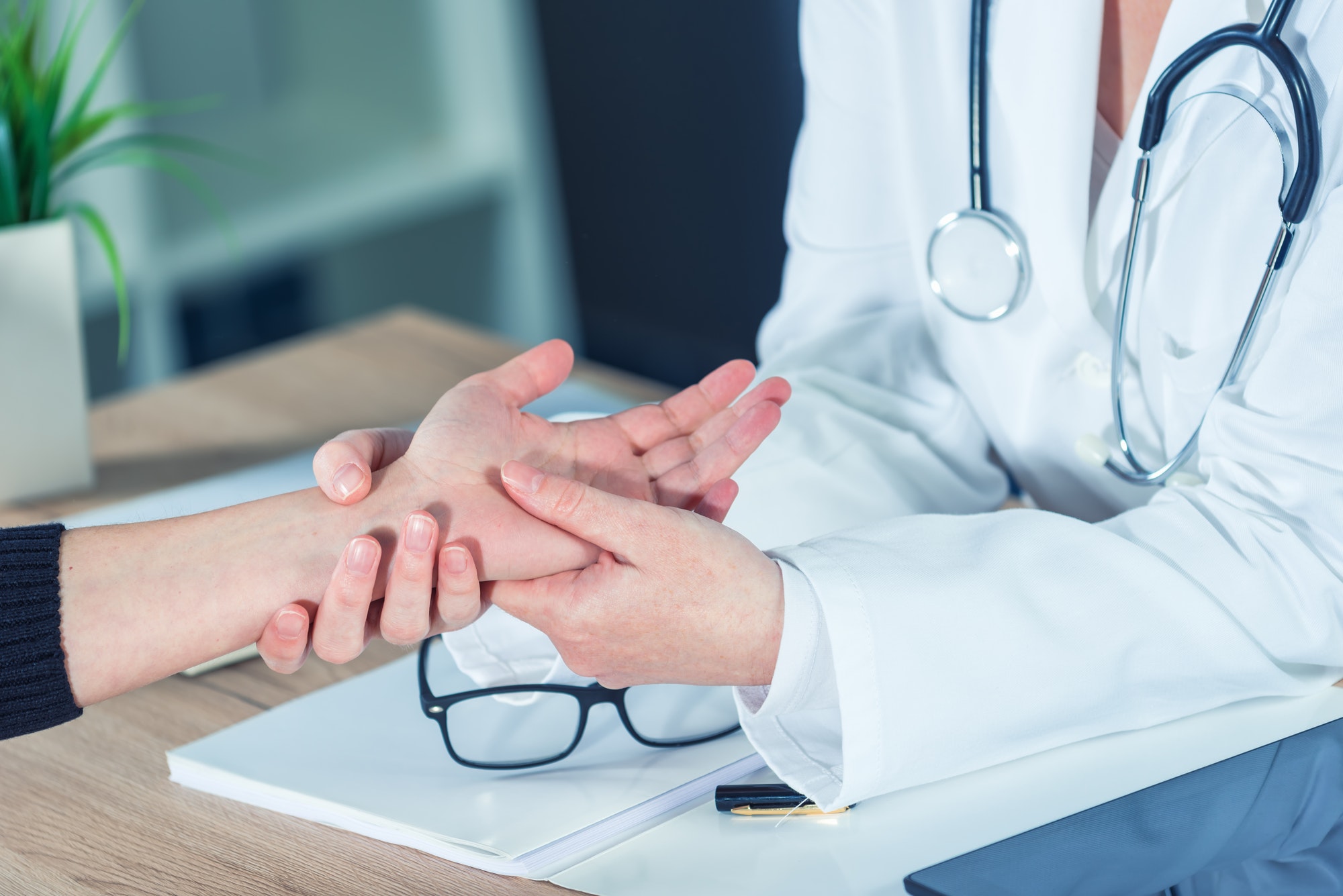 Female patient at orthopedic doctor medical exam for wrist injur