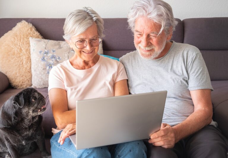 Portrait of senior caucasian people couple with old pet pug dog having good time together at home